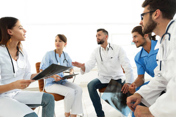 medical staff discussing x-ray of a patient