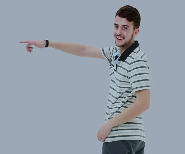 Young man pointing at something with his finger isolated on grey — Stock Photo, Image