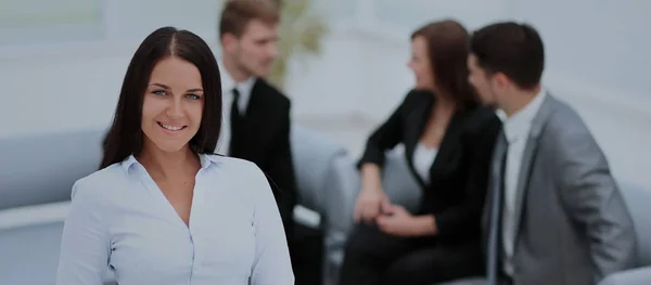 Succesvolle zakenvrouw staat met haar personeel op de achtergrond — Stockfoto