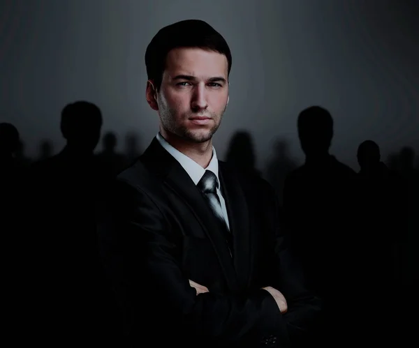 Business team standing over a dark background — Stock Photo, Image