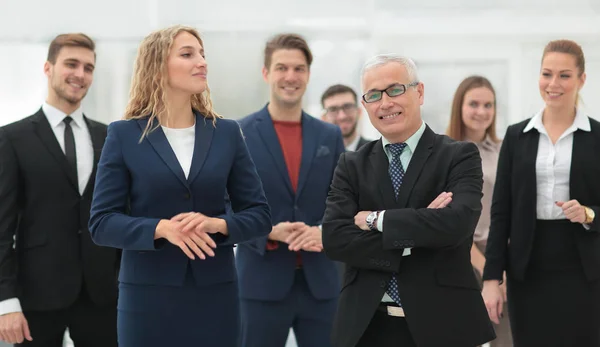 Businessman and business woman standing in front of the business team. — Stock Photo, Image