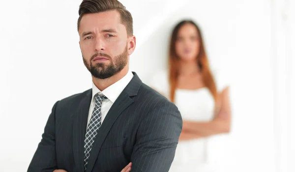 Portrait of a businessman with a woman in the background — Stock Photo, Image