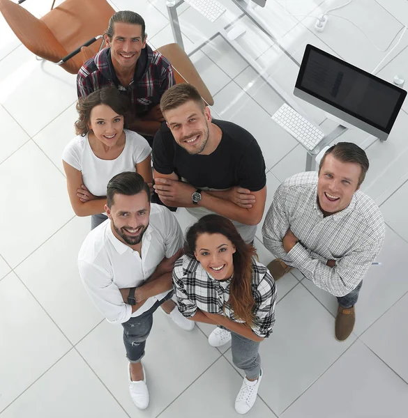 Young professionals standing near the desktop — Stock Photo, Image