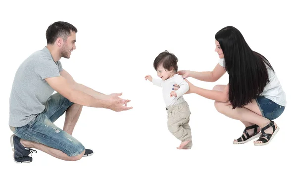 Little boy making  first steps with the help of parents — Stock Photo, Image