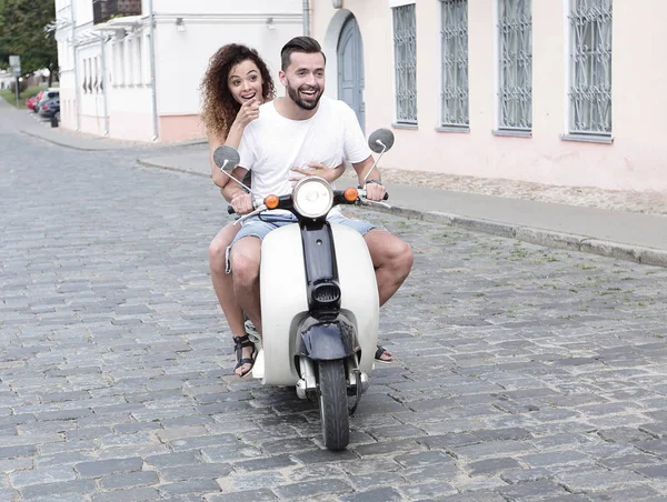 Full length side view of happy couple riding on retro motorbike — Stock Photo, Image