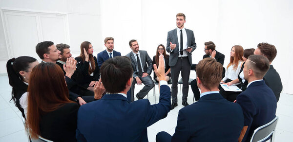 квалифицированный тренер задает вопросы участникам тренинга.