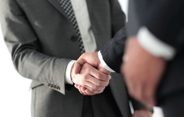 Friendly smiling businessmen handshaking. Business concept photo clipart