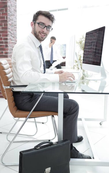 accountant sitting behind a Desk