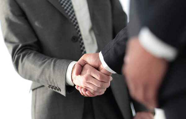 Friendly smiling businessmen handshaking. Business concept photo