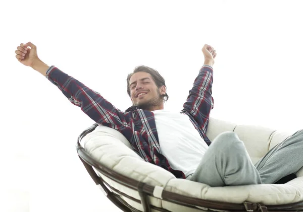 Stylish guy stretching in a comfortable chair — Stock Photo, Image