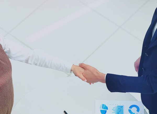 Деловые партнеры пожимают руки в зале заседаний
