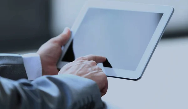 Businessman uses the tablet in a modern office — Stock Photo, Image