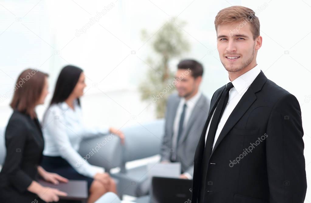 portrait of confident businessman on background of office.