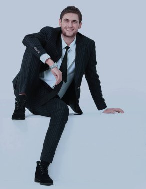 Beyaz modern iskemlede yakışıklı genç iş adamı