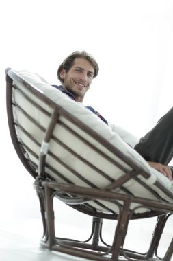 portre. adam büyük bir rahat sandalyede oturuyor dinleniyor.