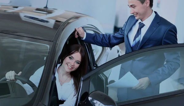 Happy woman inside car in auto show or salon — Stock Photo, Image