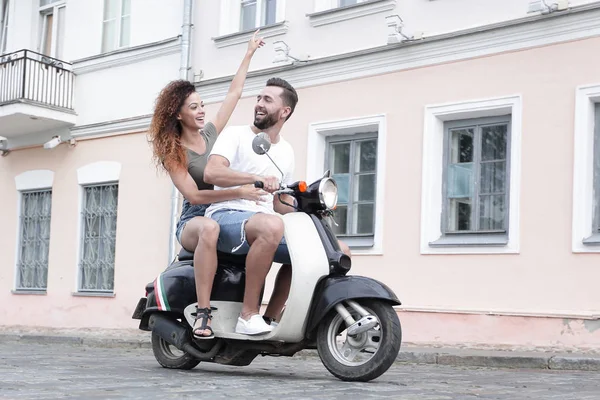 Full length side view of happy couple riding on retro motorbike — Stock Photo, Image