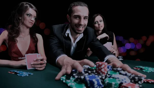 Poker player going "all in" pushing his chips forward Stock Image