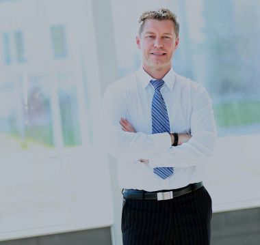 Tam boy katlanmış ellerle olgun bir işadamı portresi