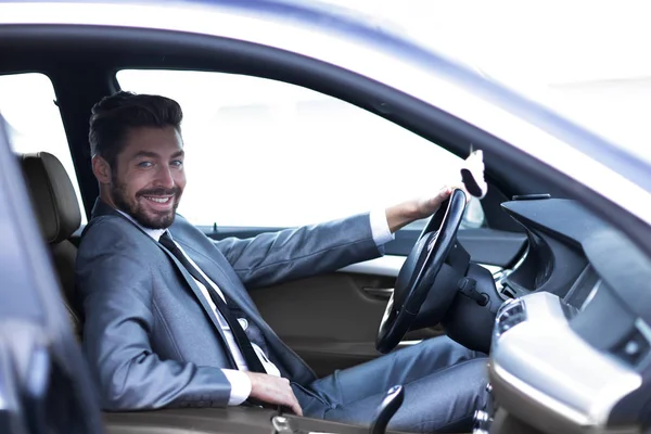 Handsome businessman in the drivers seat in his car — Stock Photo, Image