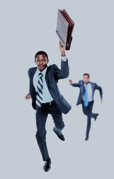 Happy afroamerican man running with a briefcase in hand. in the background- his colleague, trying to catch up him. — Stock Photo, Image