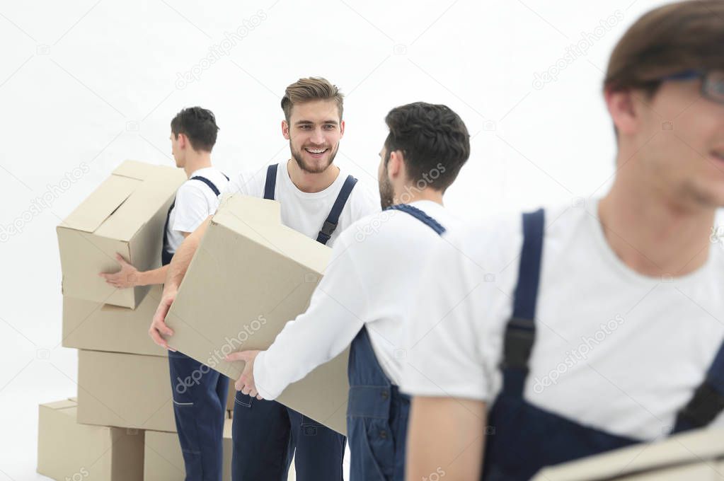 Photo workers pass each other boxes when moving flats.