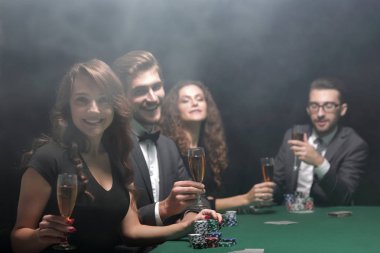 Poker oyuncuları ile bir kadeh şarap, masada oturan