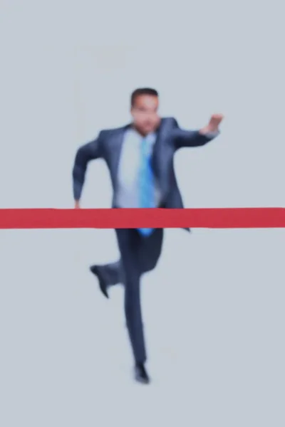 Geschäftsmann rennt vor weißem Hintergrund zum Ziel. — Stockfoto