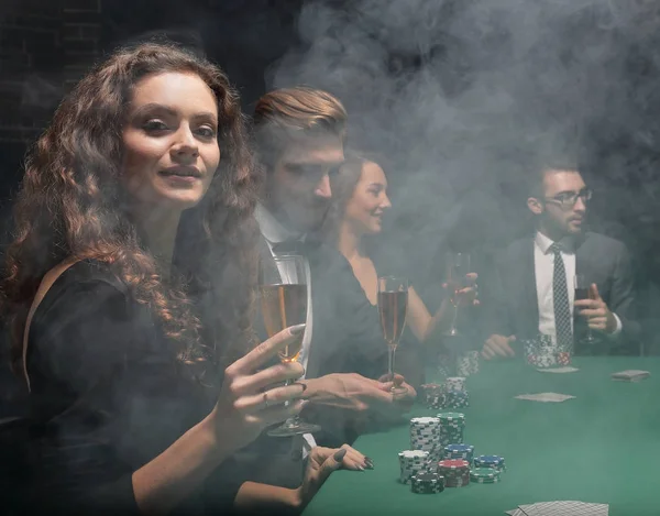 Gruppe von Freunden sitzt am Spieltisch im Casino — Stockfoto