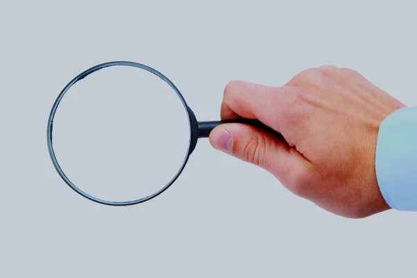 Magnifying glass in hand isolated on white background. — Stock Photo, Image