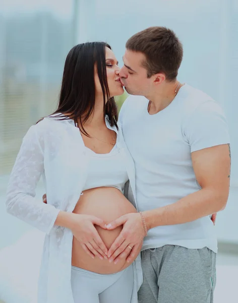 Man kissing his pregnant wife. Royalty Free Stock Images