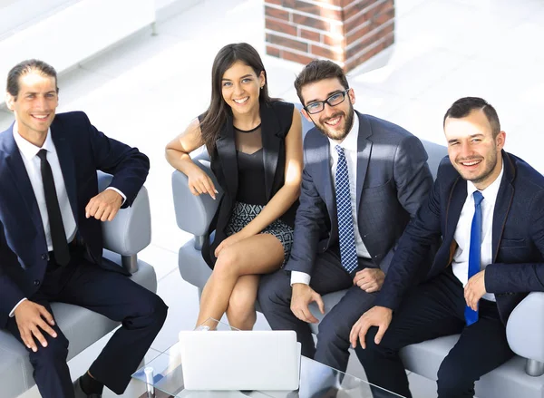 Portrait of successful business team sitting in office lobby — Stock Photo, Image