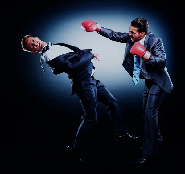 Two young businessman boxing againts dark background. — Stock Photo, Image