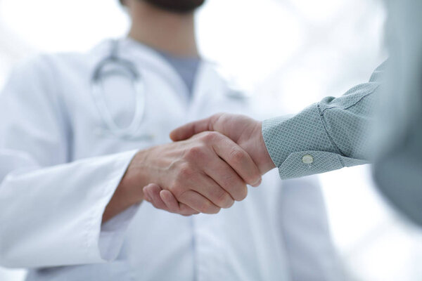 closeup.handshake between doctor and patient.