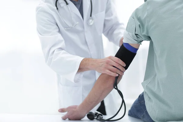 Doctor and patient measuring blood pressure Stock Photo