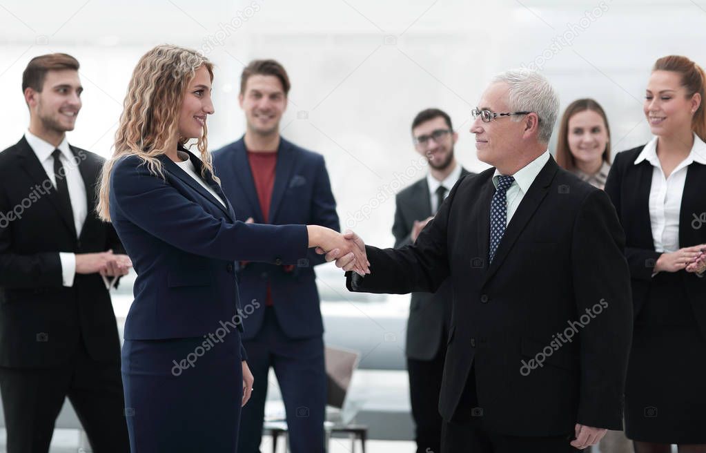 handshake serious businessman and business woman