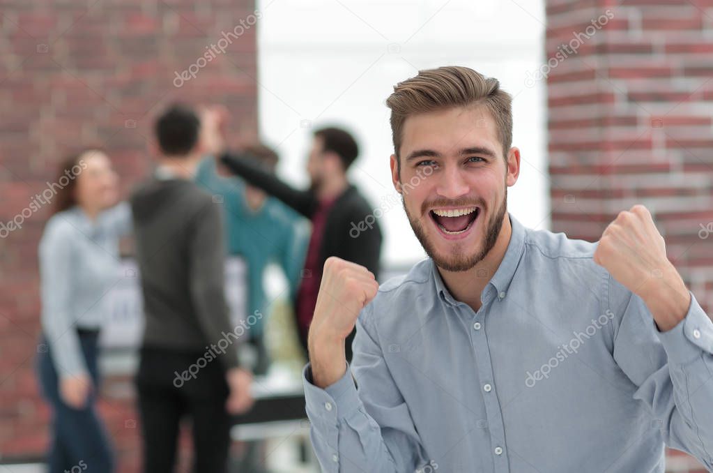 Handsome  businessman celebrating victory shouting happily in th