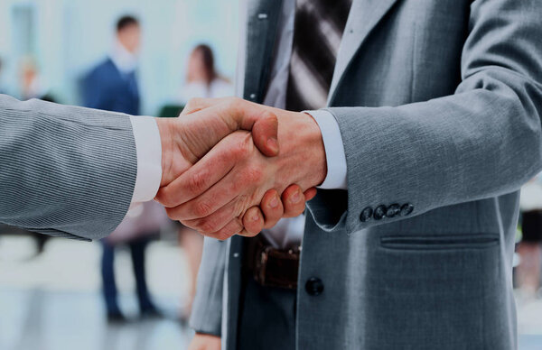 Close up of businessmen shaking hands.