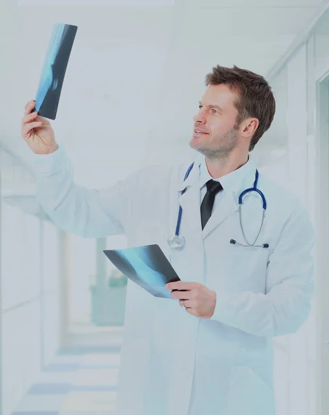 Happy doctor looking at x-ray. — Stock Photo, Image