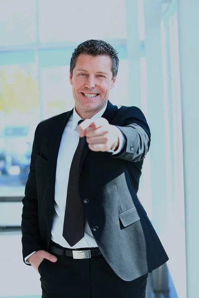 Portrait of smiling mature business man pointing at you in office. — Stock Photo, Image