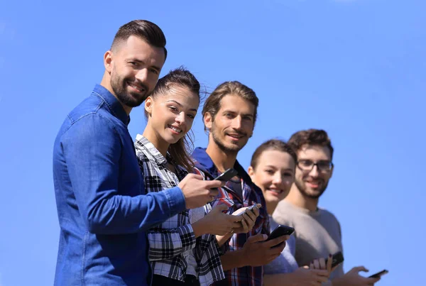 Group of young people with modern smartphones. — Stock Photo, Image