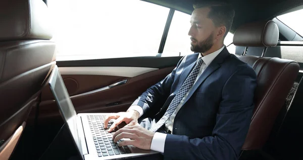 Podnikatel, pracovat s notebookem sedět v autě — Stock fotografie