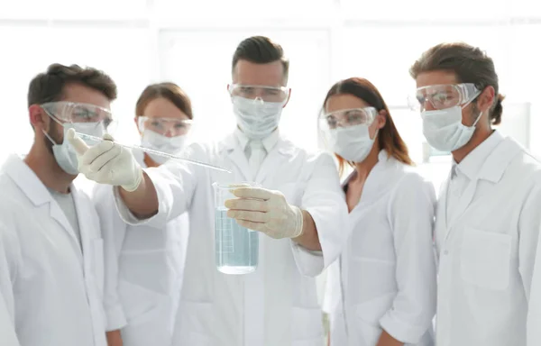 Closeup of a group of medical workers working with liquids — Stock Photo, Image
