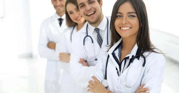 Female doctor with group of happy successful colleagues — Stock Photo, Image