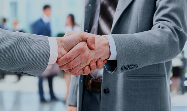 Close up of businessmen shaking hands.