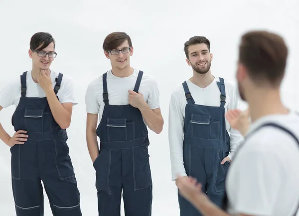 Vrolijke team van verantwoordelijk verhuizers en hun lachende leider. — Stockfoto