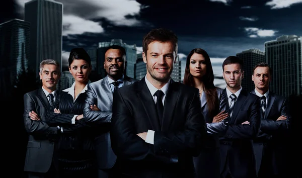 Business team standing over a dark background. — Stock Photo, Image