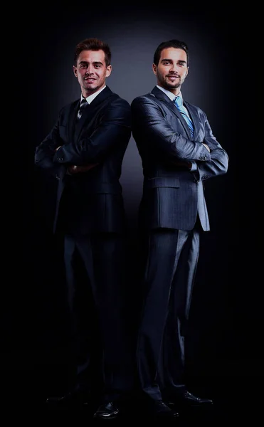 Two young businessmen full body, isolated on black. — Stock Photo, Image