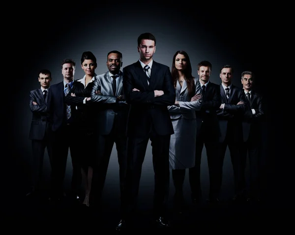 Business team standing over a dark background. — Stock Photo, Image