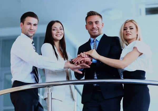 Portrait of positive business group standing on stairs of modern building.
